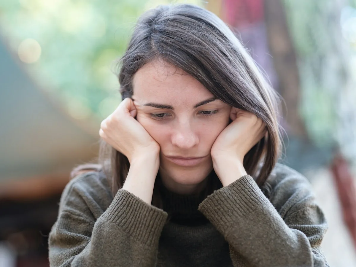 Woman resting her face in her hands, feeling anxious during gabapentin withdrawal
